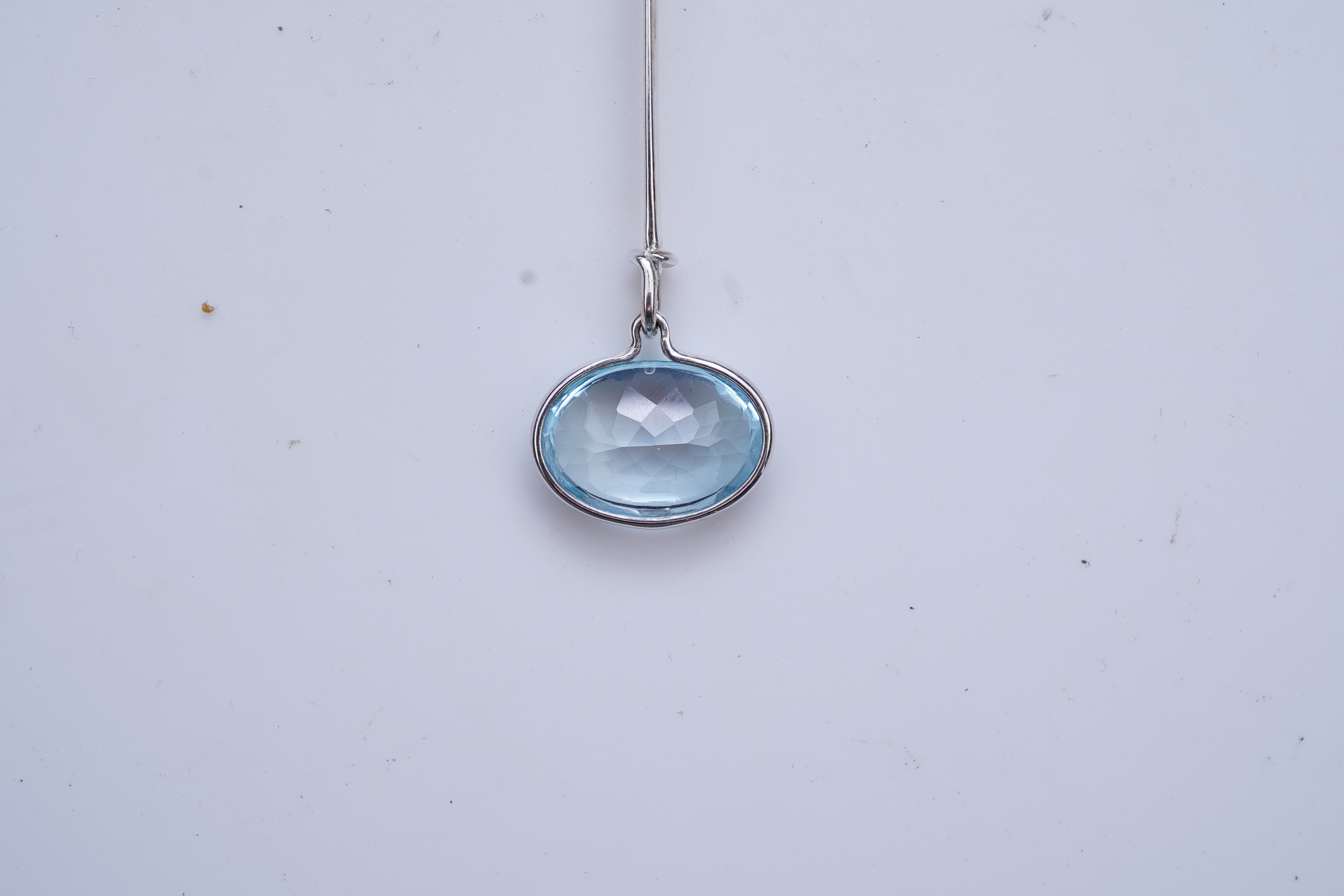 Georg Jensen, a blue topaz necklace, centring on a hook clasp suspending an oval blue topaz pendant, pendant length 5.5cm, necklace length 43cm, stamped GJ for Georg Jensen, 925S and European convention assay marks for s